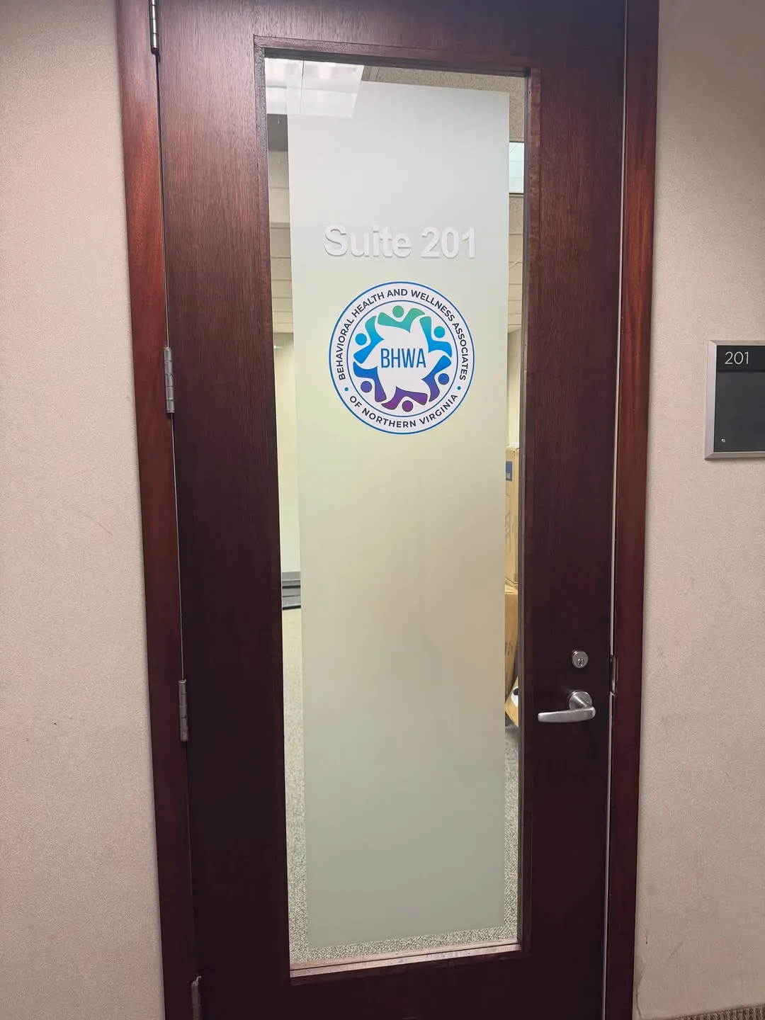 Frosted vinyl privacy decal applied to a suite entry door glass panel
