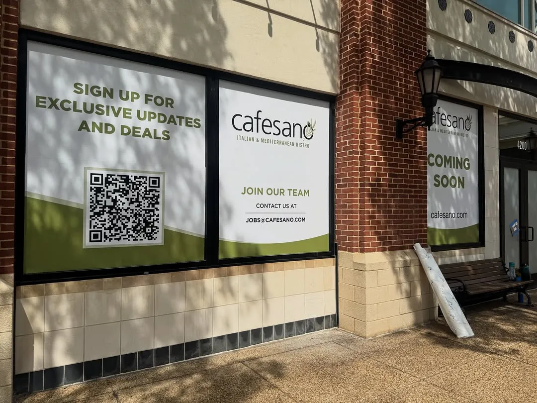 Cafesano storefront window graphics with a QR code panel on a brick facade